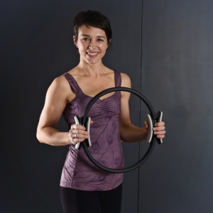 Woman Holding on Aeropilates Magic Circle.