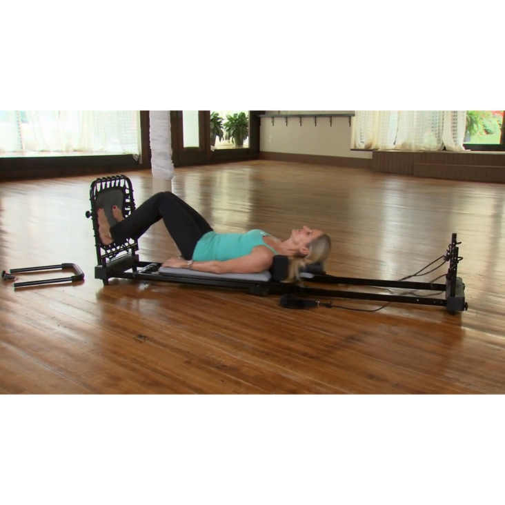 Middle age woman lying on pilates while usisng AeroPilates Fat Burning Cardio