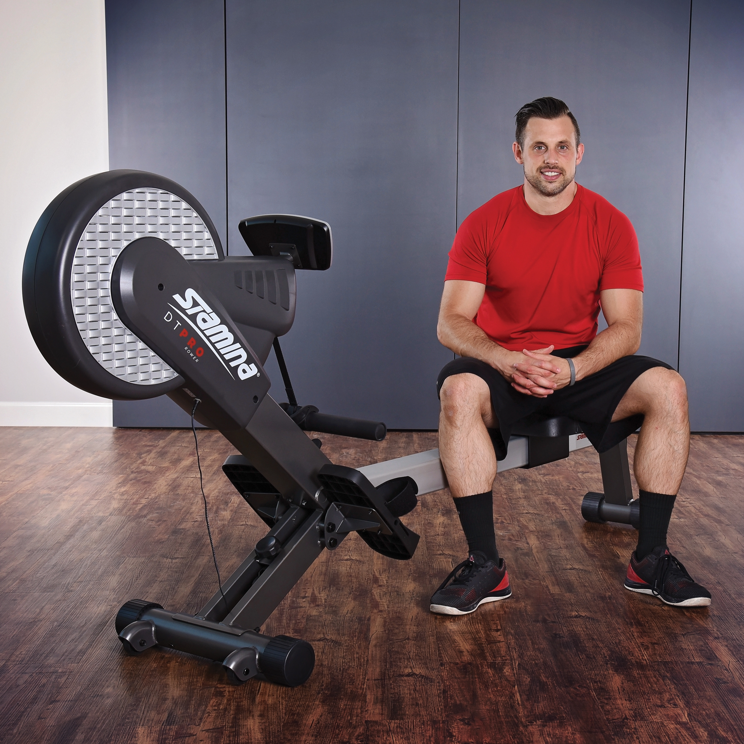 Middle age man seated on Stamina DT Pro Rower.