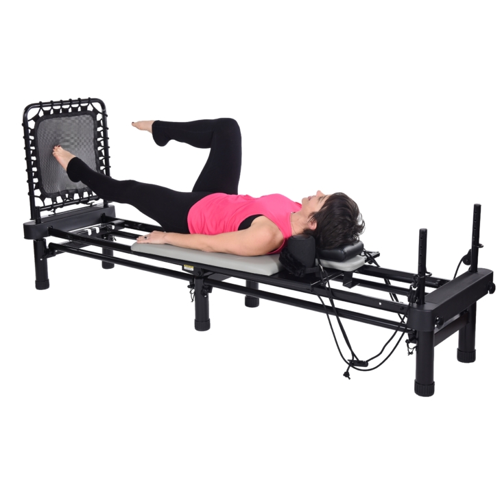Woman bent knee and toe touch on Aeropilates Rebounder.