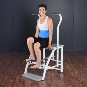 Woman seated and stepping on Aeropilates Chair.