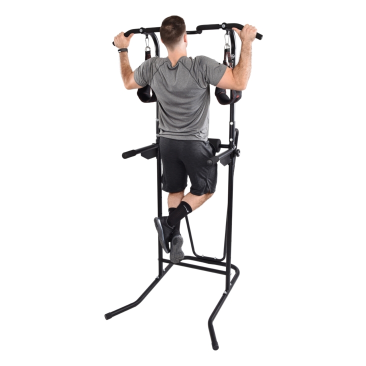 Man pulling himself using stamina power tower at a side handle bars.